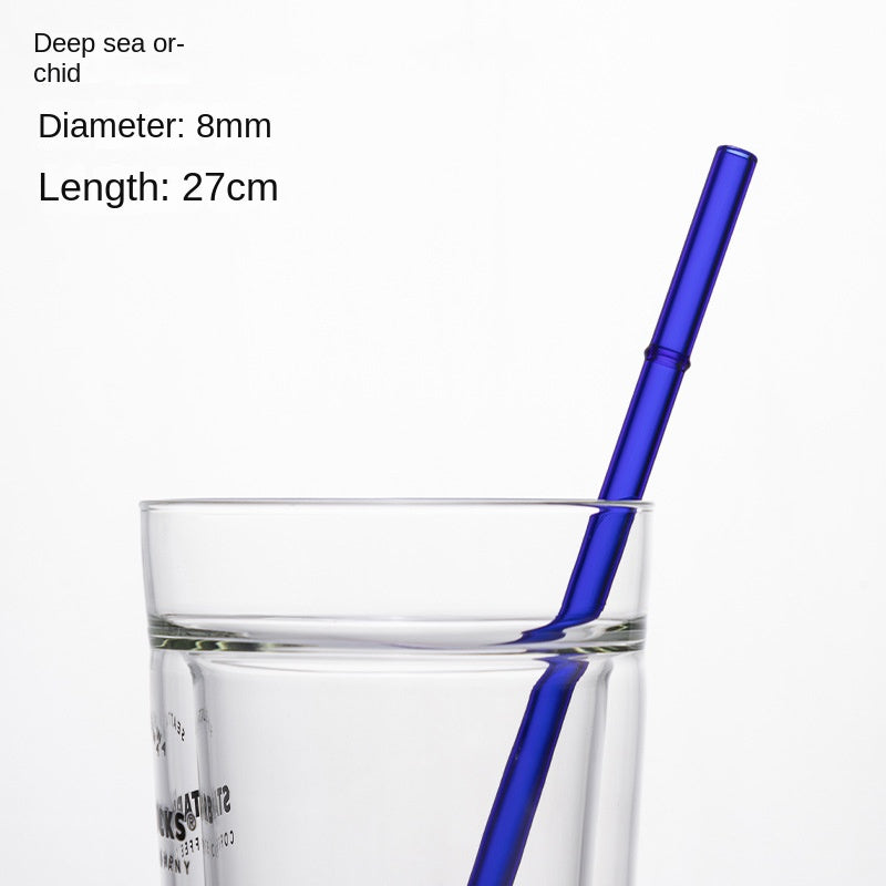 Deep blue borosilicate glass drinking straw, 8mm diameter, 27cm long, in a glass