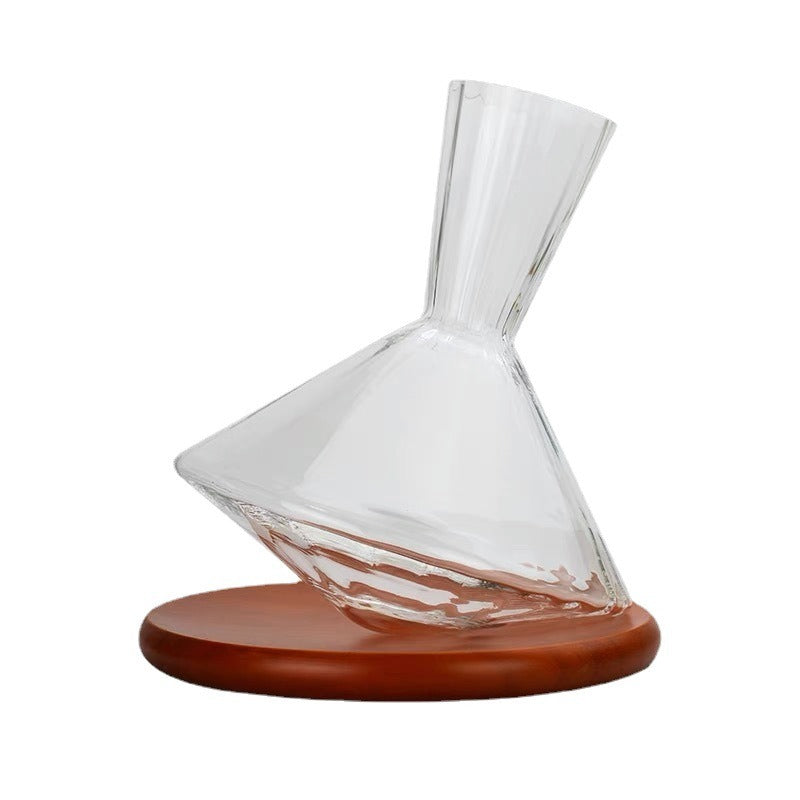 Clear crystal wine decanter with flared neck and brown wooden base