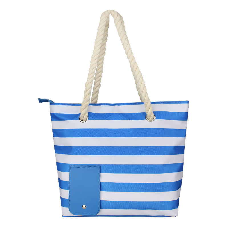 Blue-and-white striped wine tote bag with rope handles and blue front pocket.