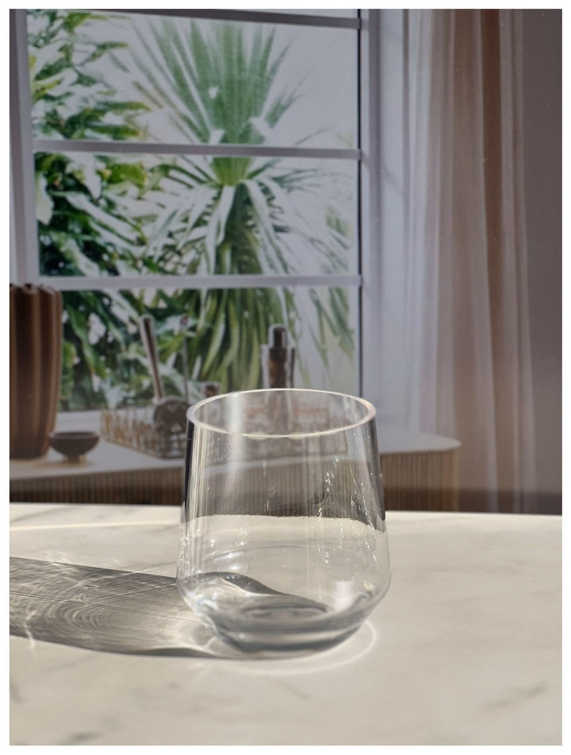 Clear wine glass with water, showing condensation and reflections