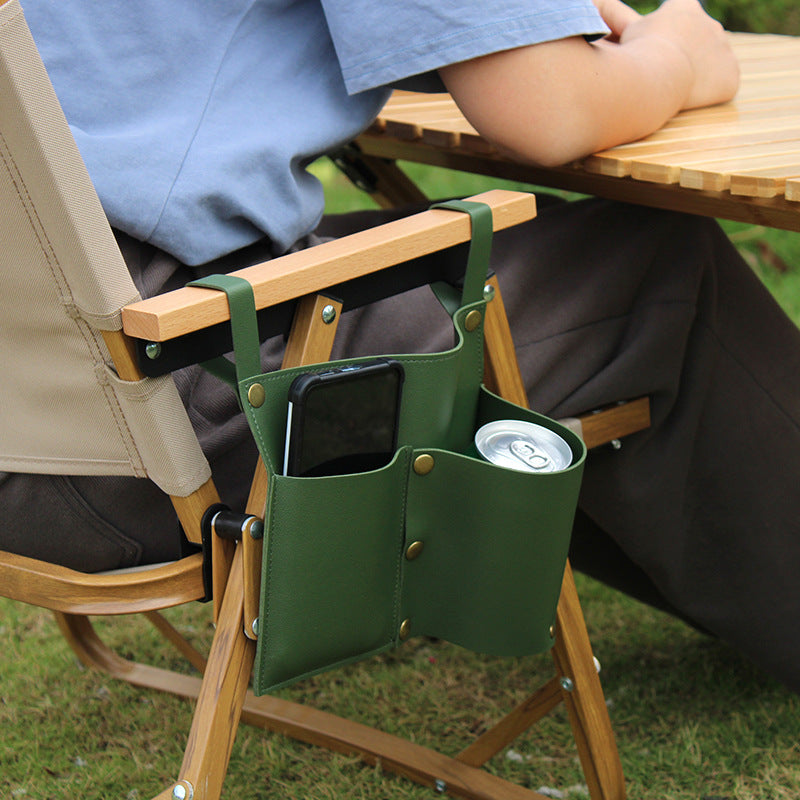 Green camping chair side storage bag clipped to chair arm with drink cup pocket