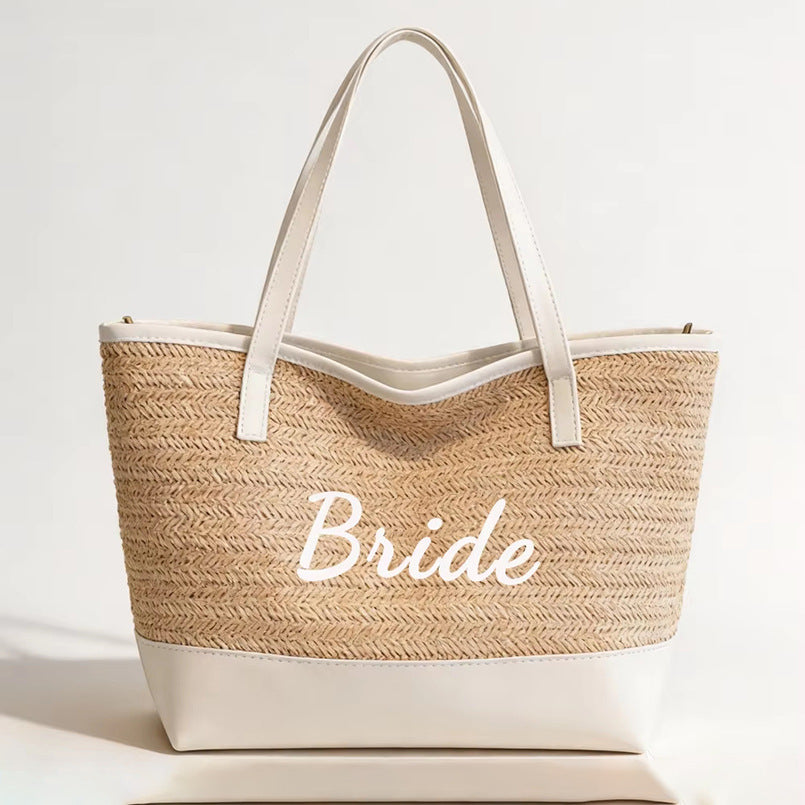 Light khaki large tote bag with white bottom, 'Bride' cursive, double handles