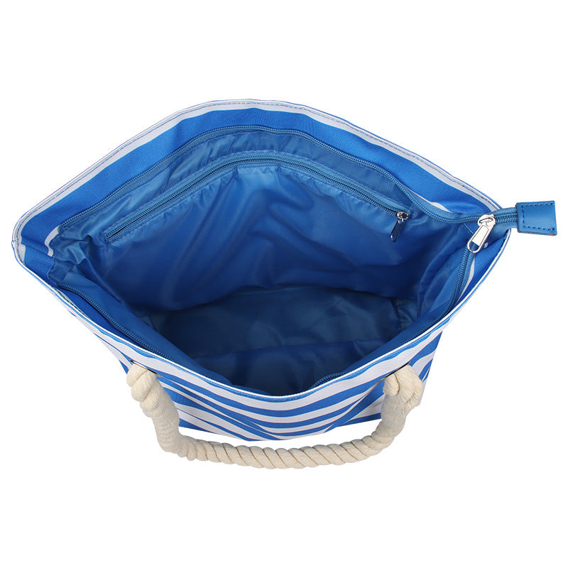 Open blue-and-white striped insulated tote bag with zip closure and rope handles.