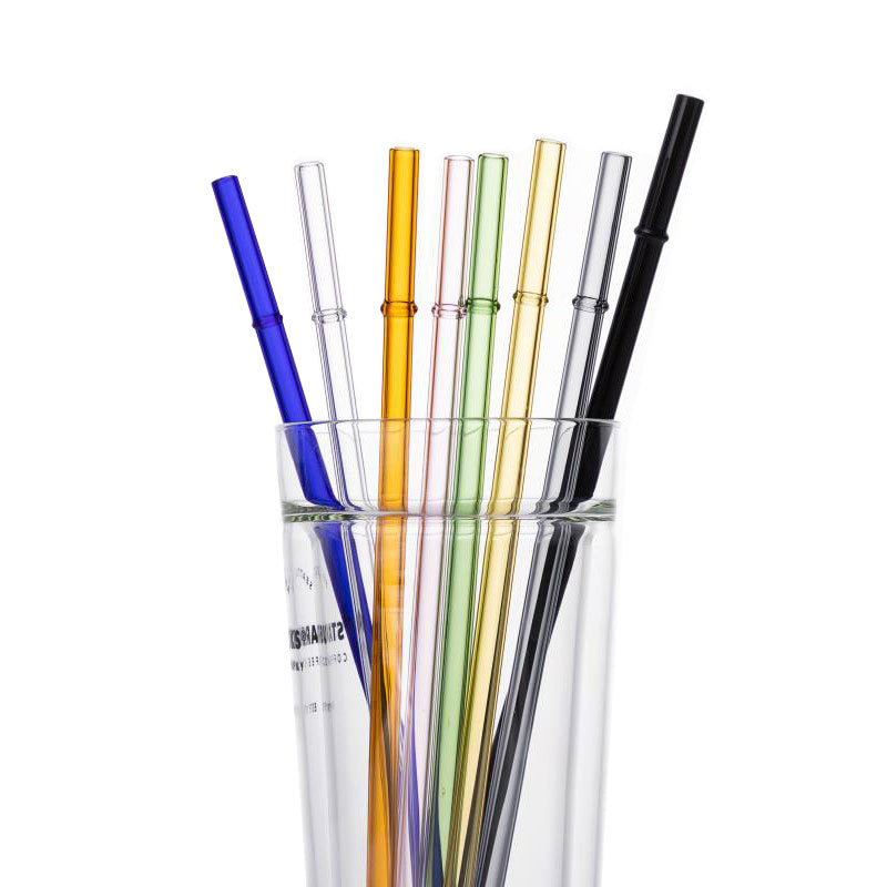 Borosilicate glass drinking straw set, assorted color tubes standing in a clear cup
