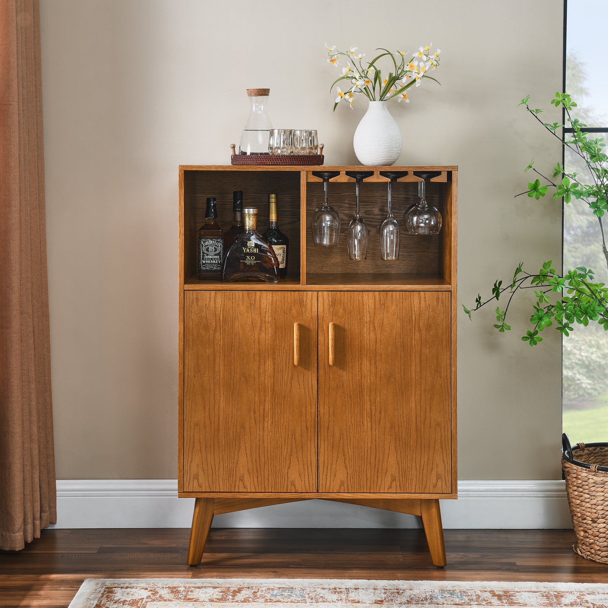 Wood beverage cabinet with two doors, bottle storage, and hanging glass holders