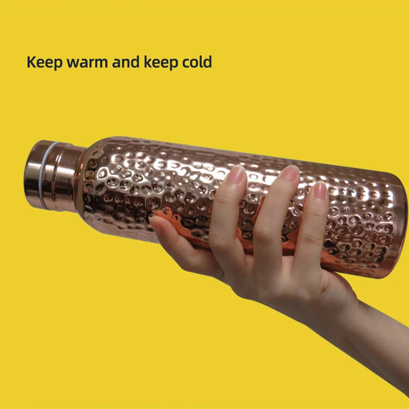 Noble copper 620ml vacuum insulated thermos flask held in hand with stainless cap