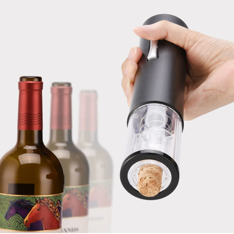Black electric wine bottle opener being held over a wine bottle opening