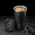 Black insulated travel mug with clear lid, ribbed sleeve, and drinking coffee