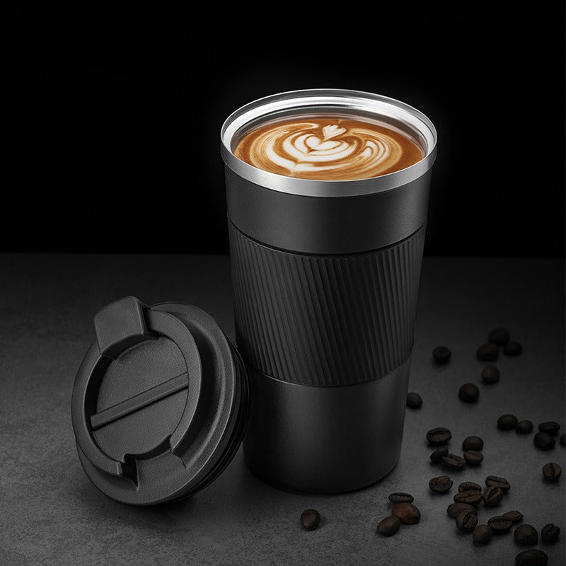 Black insulated travel mug with clear lid, ribbed sleeve, and drinking coffee