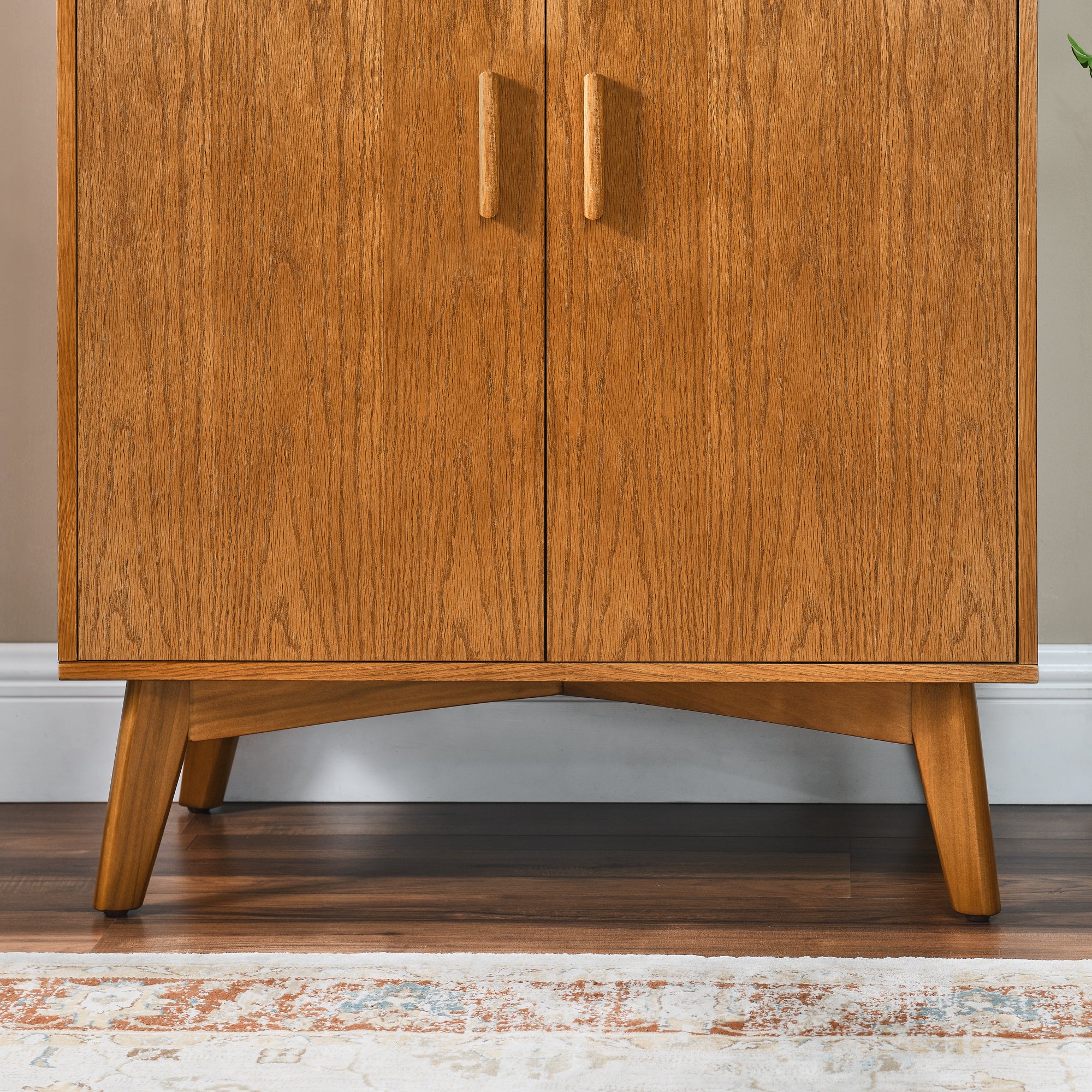 Wood cabinet doors with vertical handles and tapered legs, front view