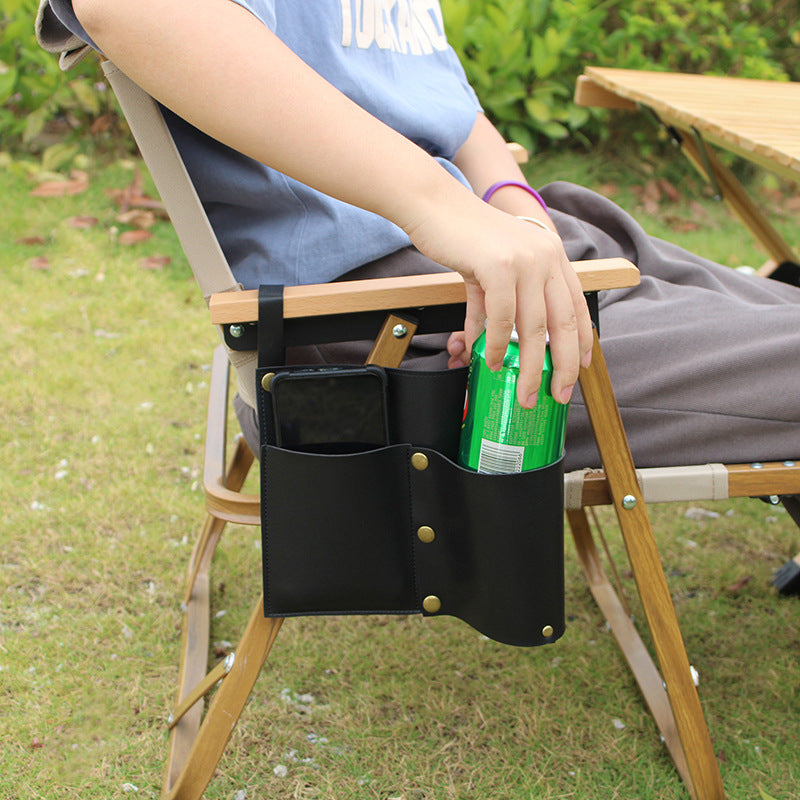 Black camping chair side storage bag holding bottle and phone in side pockets