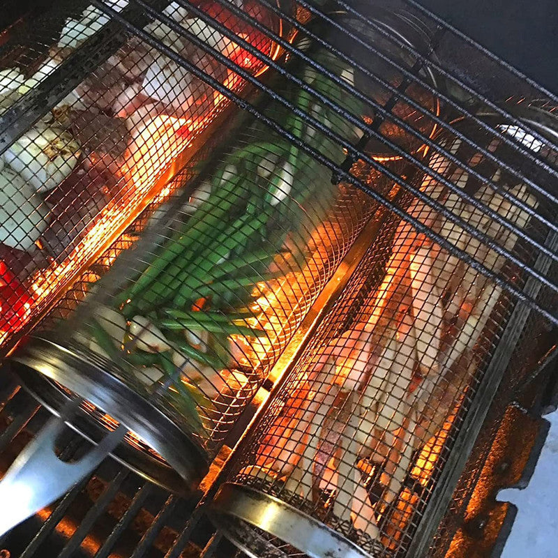 Stainless steel mesh basket in a grill filled with assorted vegetables.