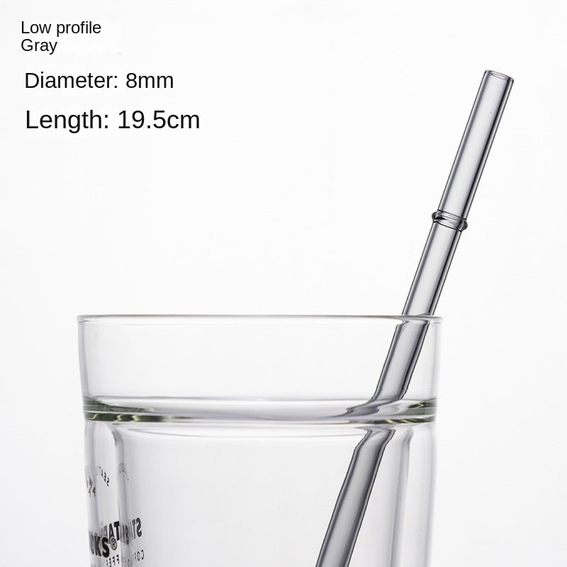 Low-profile gray borosilicate glass drinking straw in a clear cup