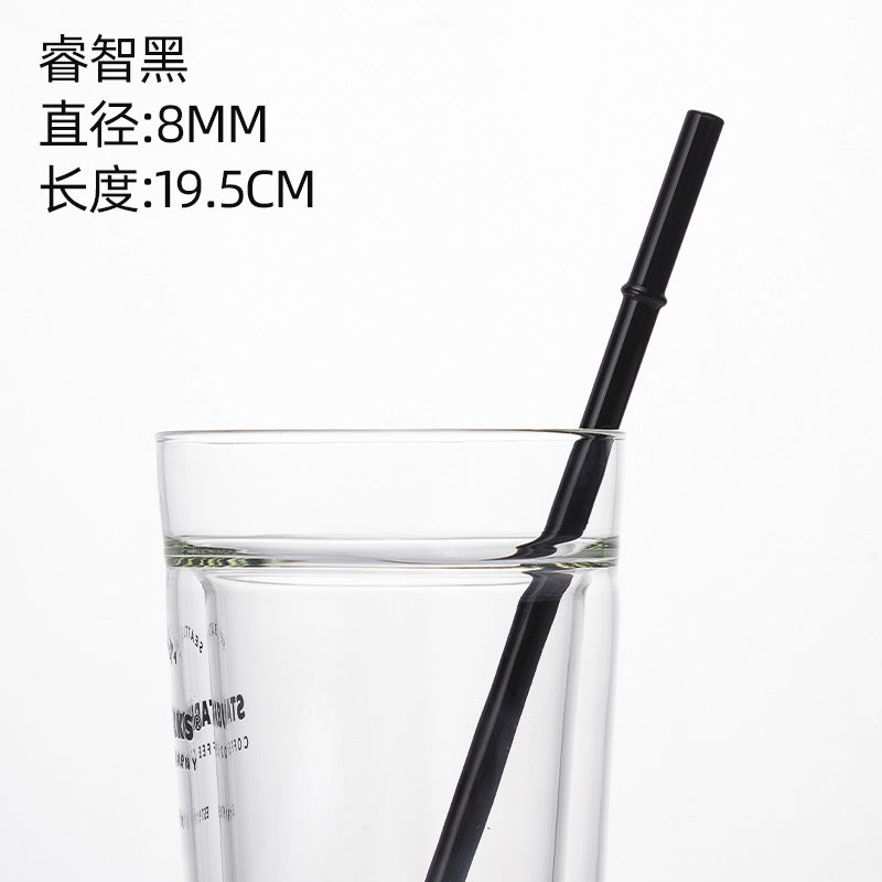 Black borosilicate glass drinking straw in a clear cup