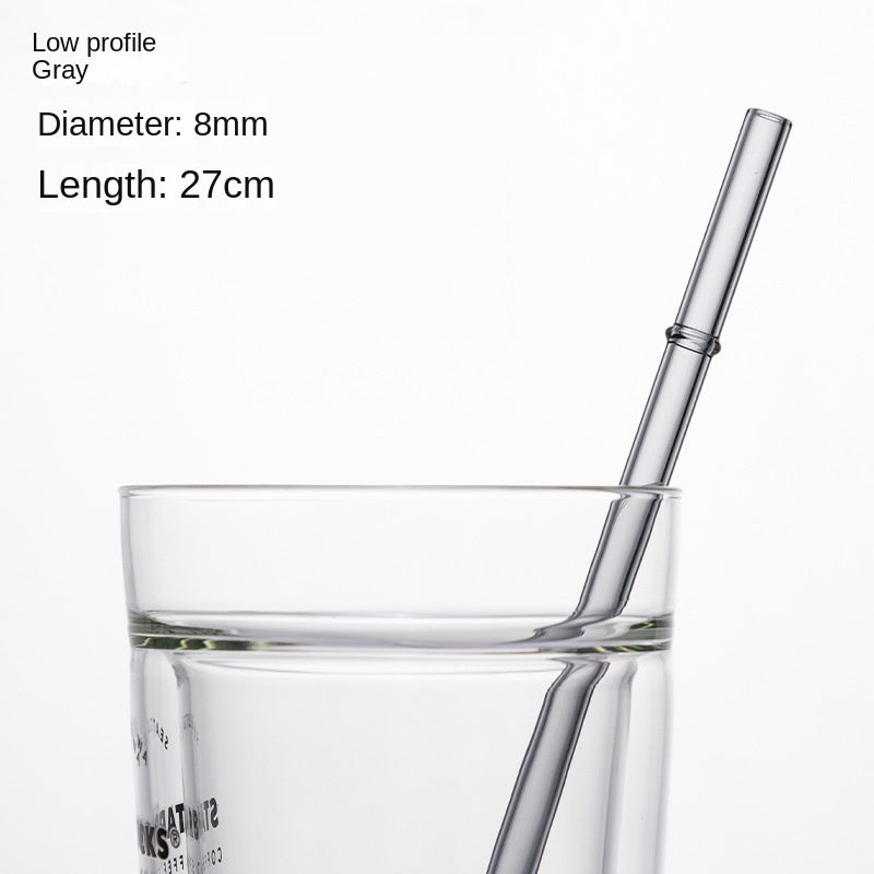 Low-profile gray borosilicate glass drinking straw, 8mm diameter, 27cm long, in a glass