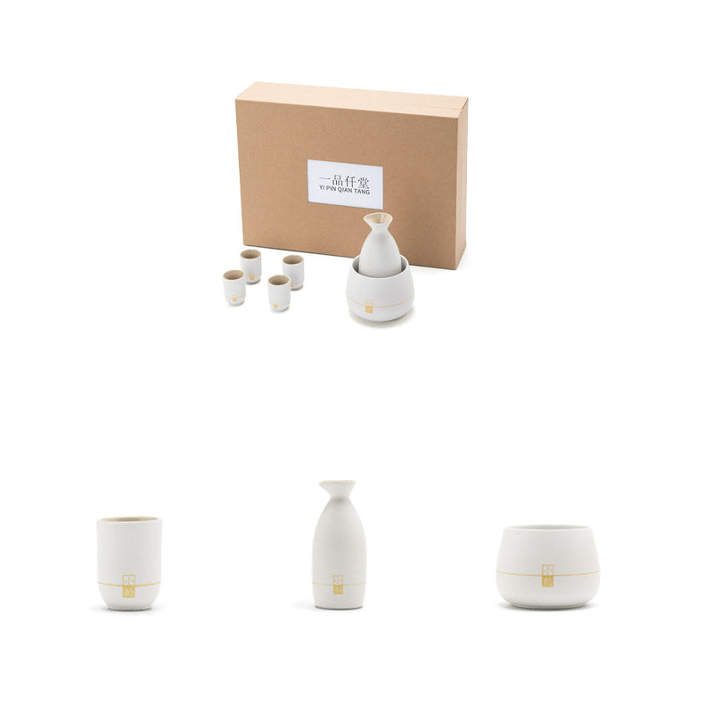 Ceramic electric wine warmer set with small cups, bottle-shaped warmer, and heating base