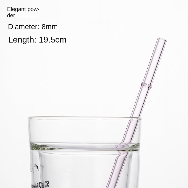 Elegant pink borosilicate glass drinking straw in a clear cup