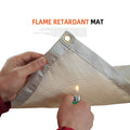 Fireproof camping blanket mat, light gray fabric with corner grommet; held in hands