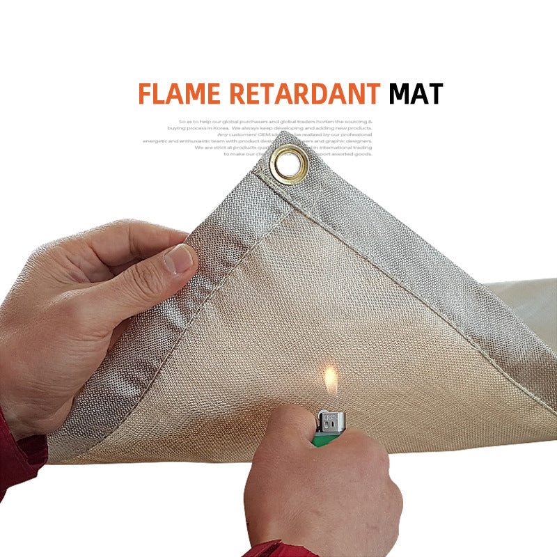 Fireproof camping blanket mat, light gray fabric with corner grommet; held in hands
