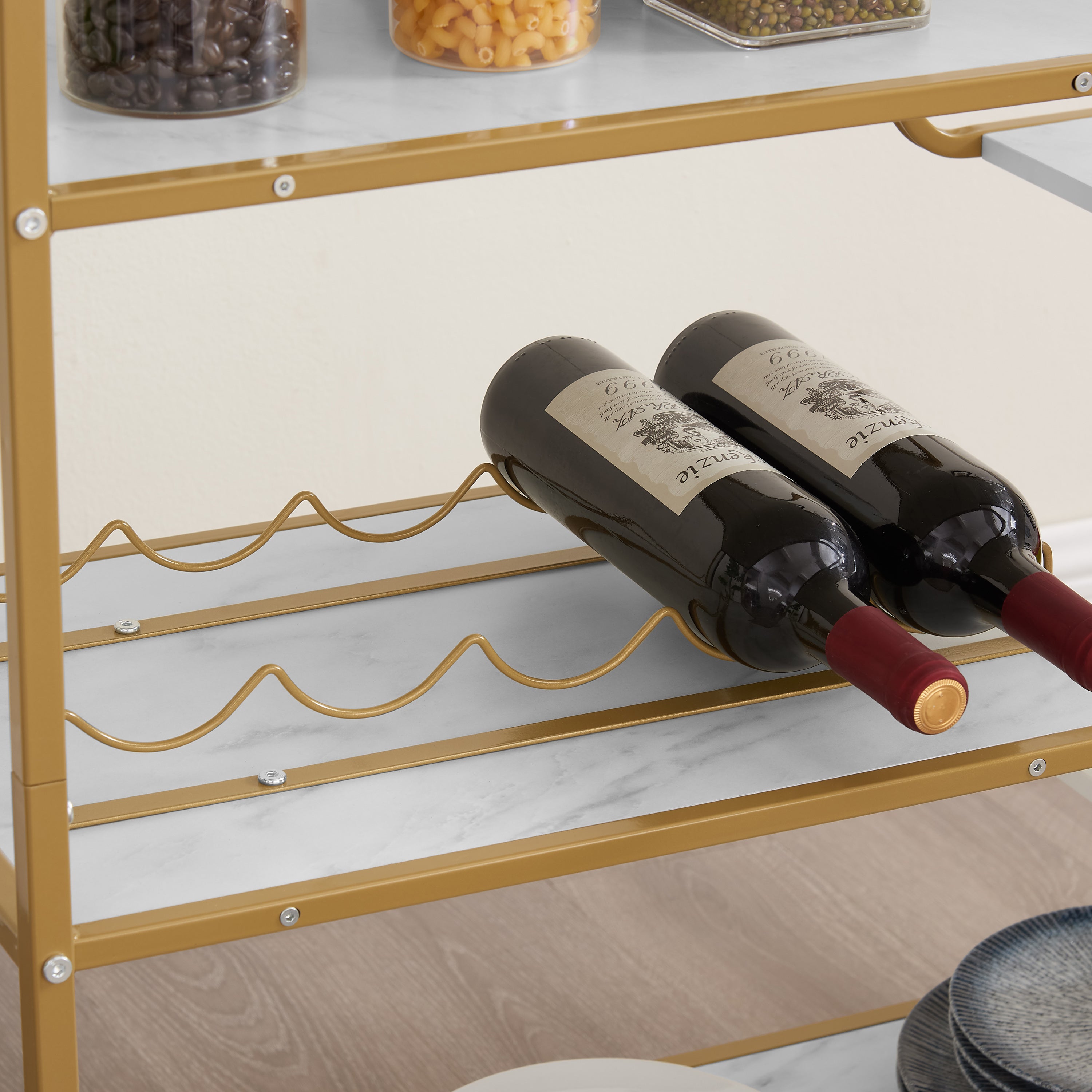 Gold wine rack shelf on a 6-tier bar cart holding dark wine bottles