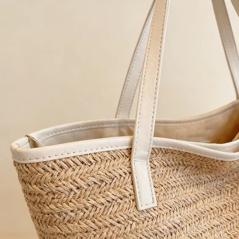 Light khaki woven tote top with white leather handles and stitched trim