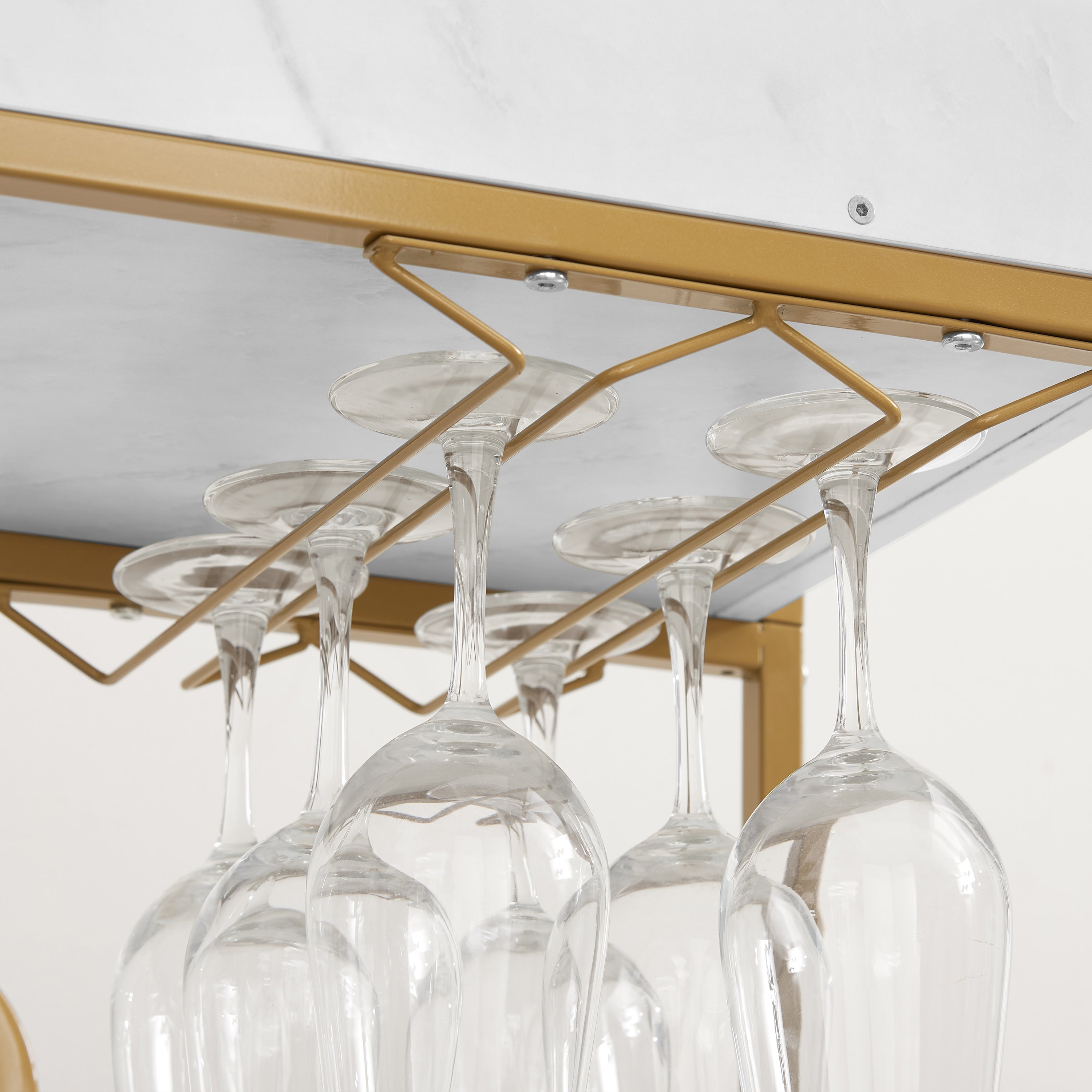Under-shelf stemware holder on a gold 6-tier bar cart with hanging wine glasses