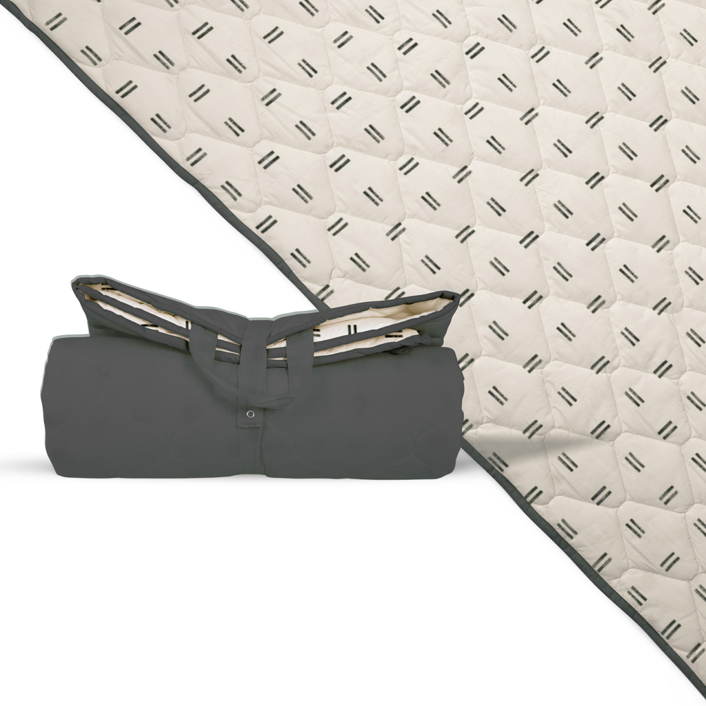 Extra-large waterproof picnic blanket, off-white with repeating black mudcloth pattern, folded