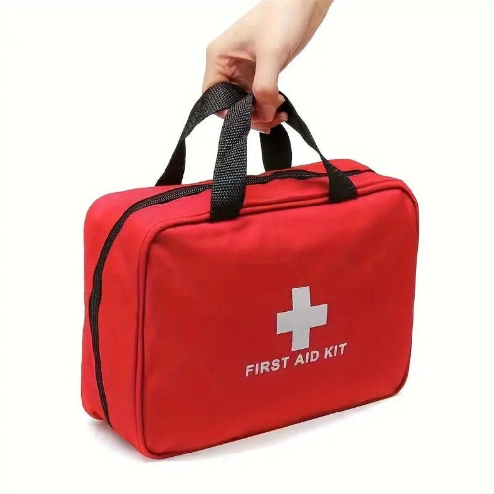 Red first aid kit bag with black carry handles and white medical cross logo